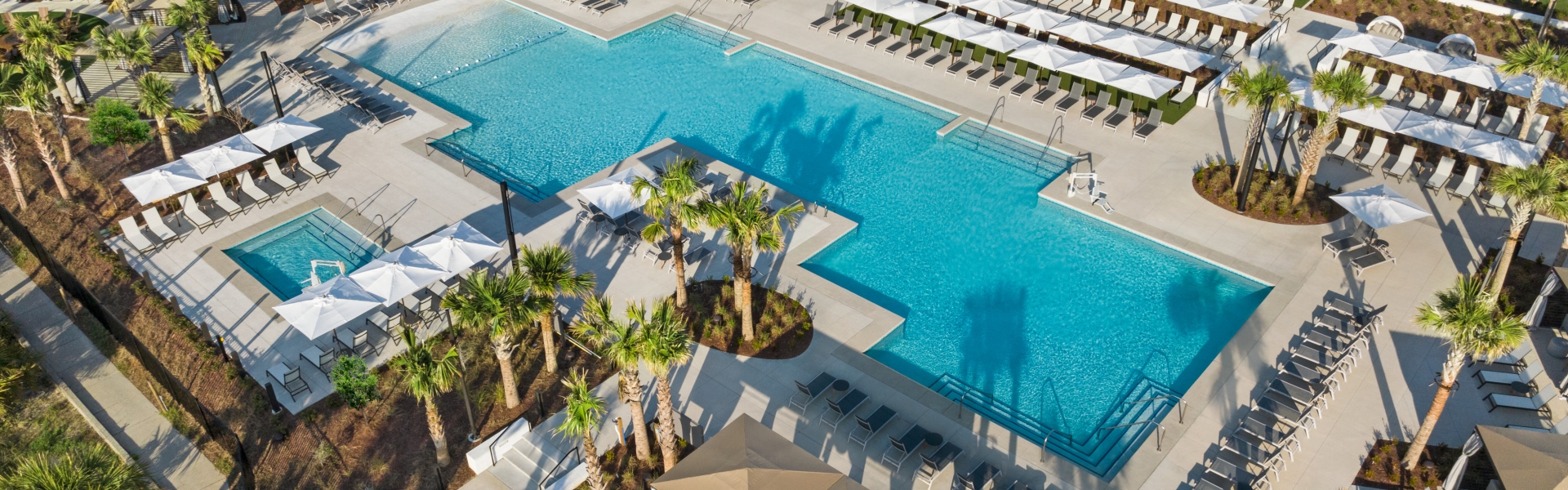 Currents Seaside Entertainment drone view with Black Drum Brewing in the background