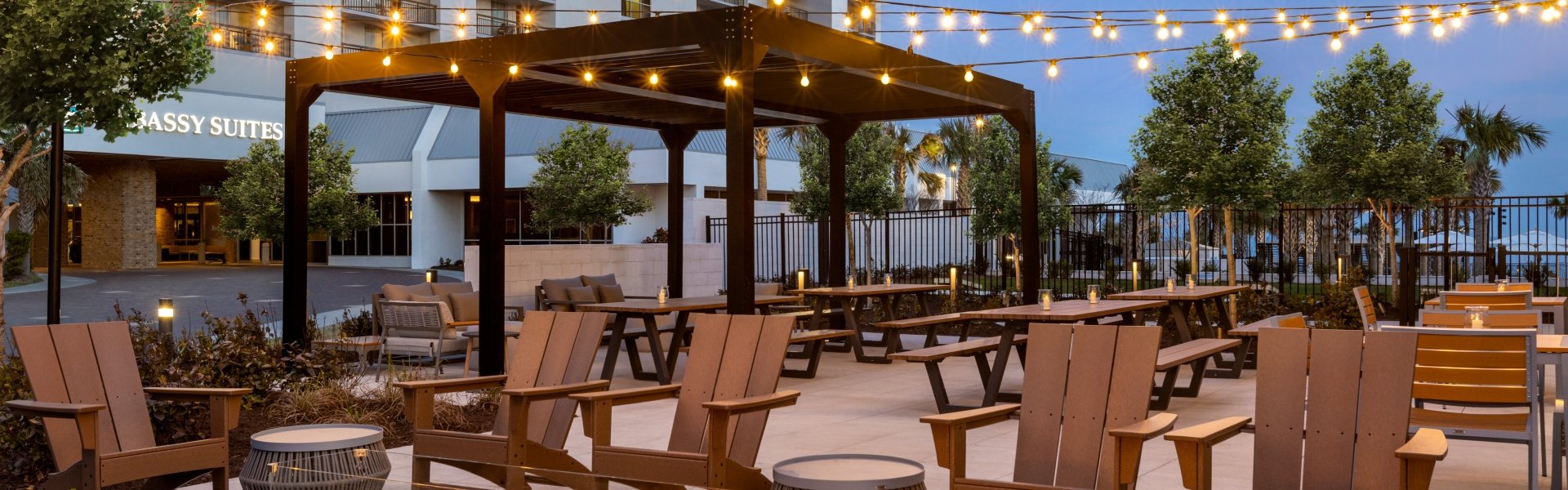 Black Drum Brewing beer garden with seating areas and a long firepit