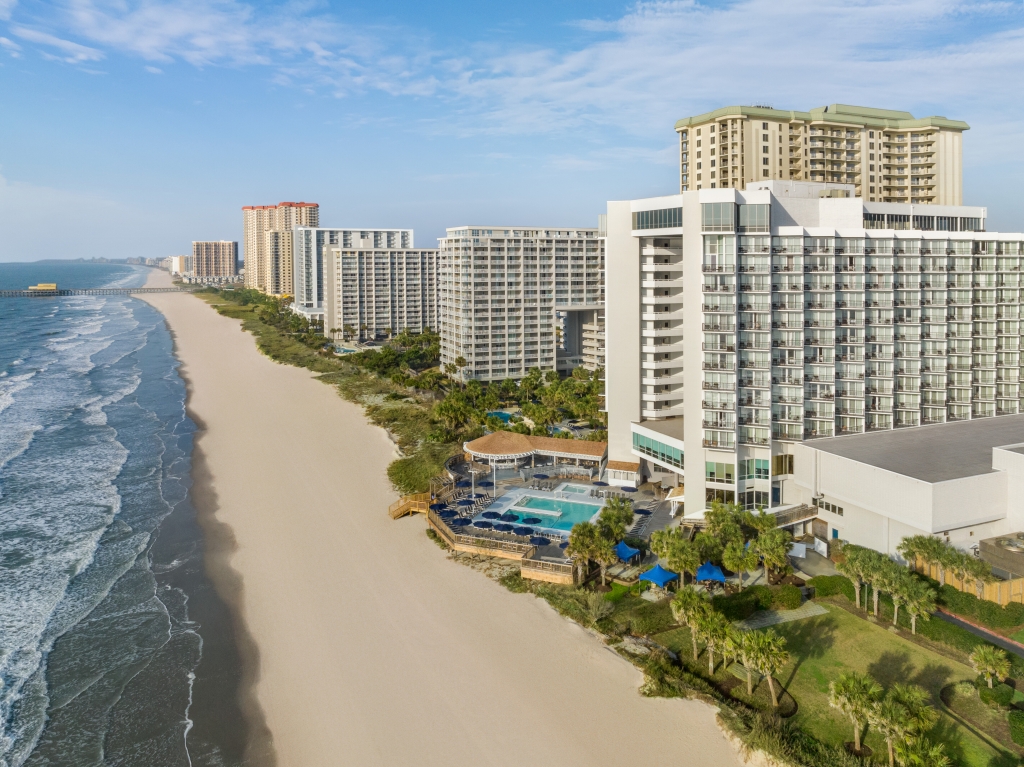 An aerial shot of Myrtle Beach with hotels and condos in the coast.