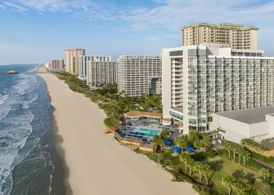 An aerial shot of Kingston Resorts starting at Hilton and looking down towards The Apache Pier