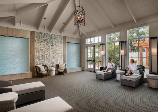 Two ladies enjoying mimosas in Spa33 relaxation room