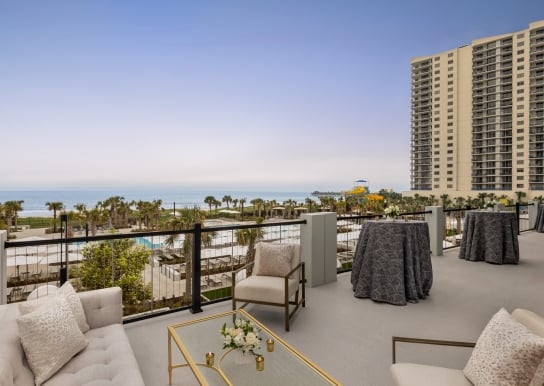 Seaside Vista terrace with soft seating and cocktail tables. You have a direct view of the ocean