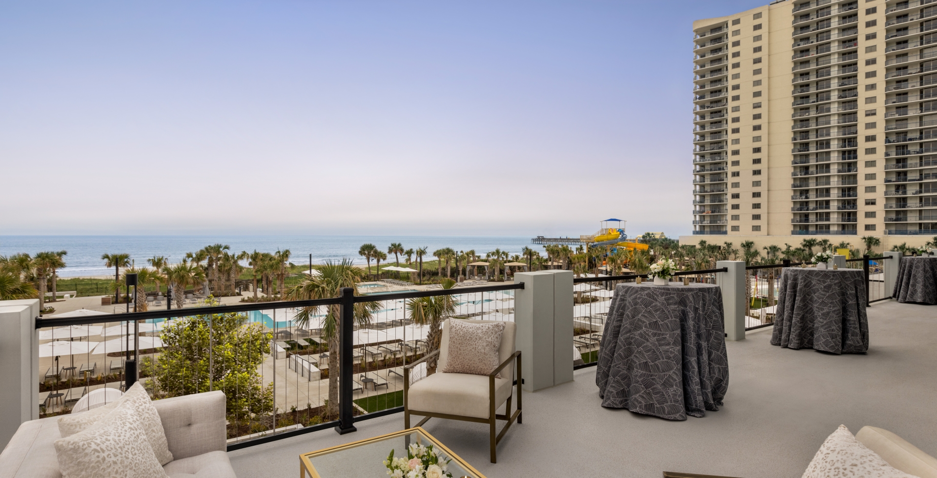 Seaside Vista terrace with soft seating and cocktail tables. You have a direct view of the ocean