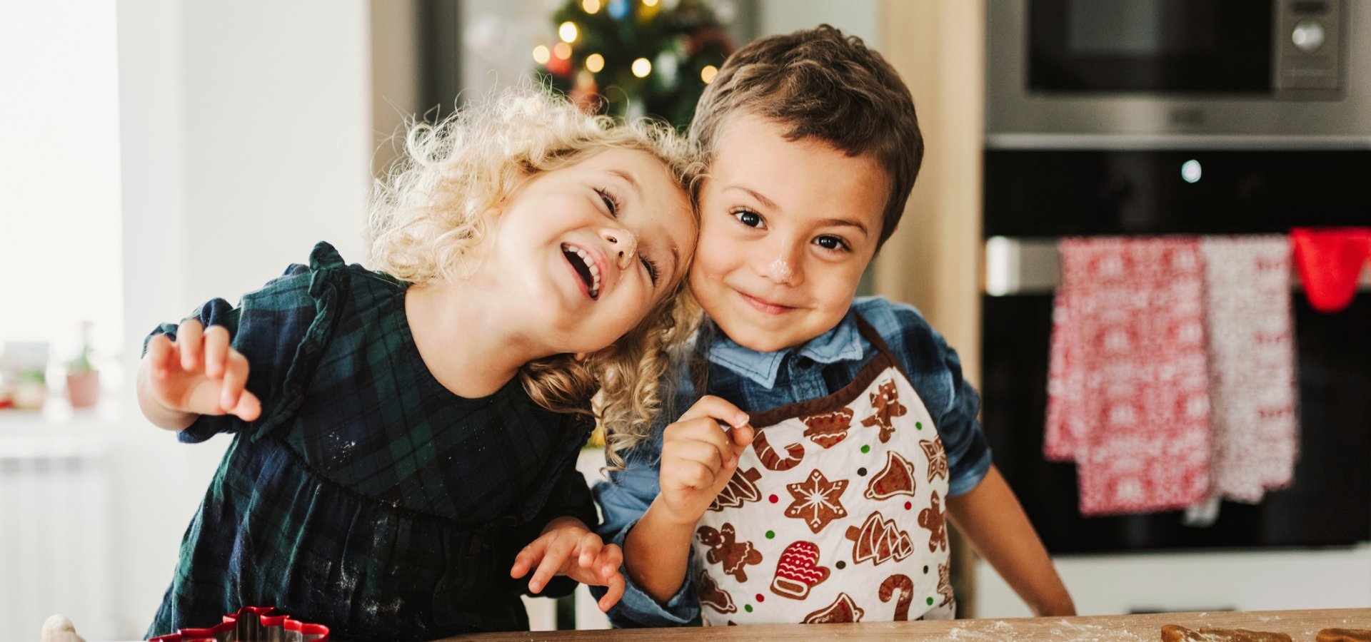 Two children baking Christmas cookies