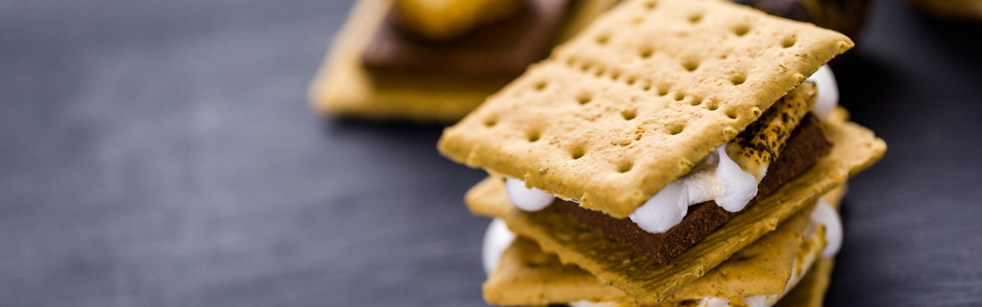 Freshly toasted smores with large white marshmallows.