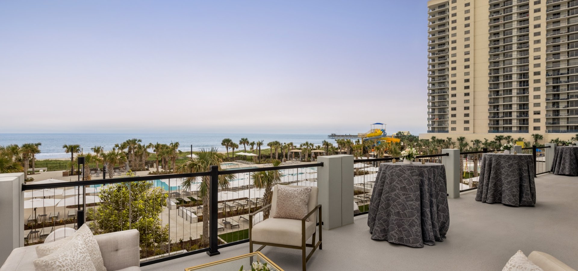 Seaside Vista terrace with soft seating and cocktail tables. You have a direct view of the ocean
