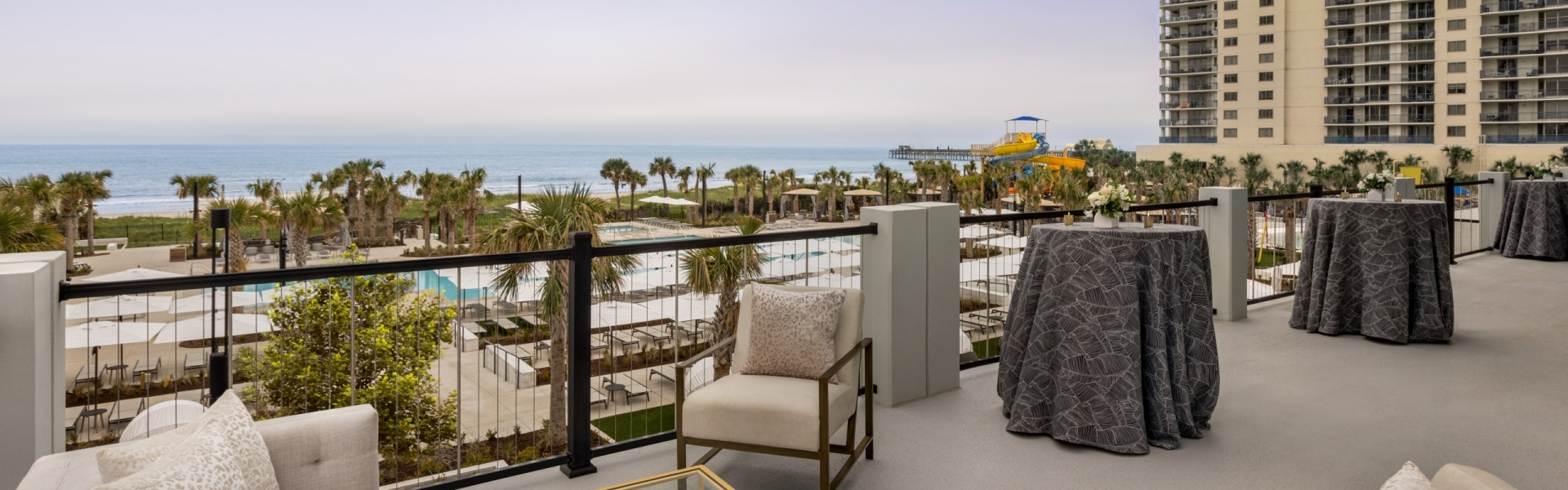 Seaside Vista terrace with soft seating and cocktail tables. You have a direct view of the ocean