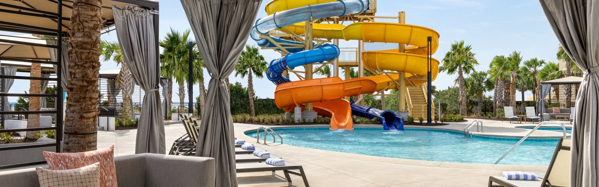 View of Currents Seaside Entertainment waterslides from inside of a cabana