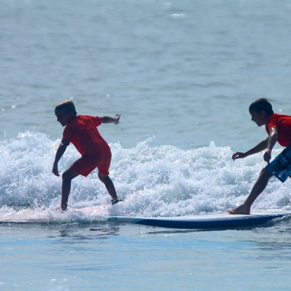 Two boys surfing in the ocean