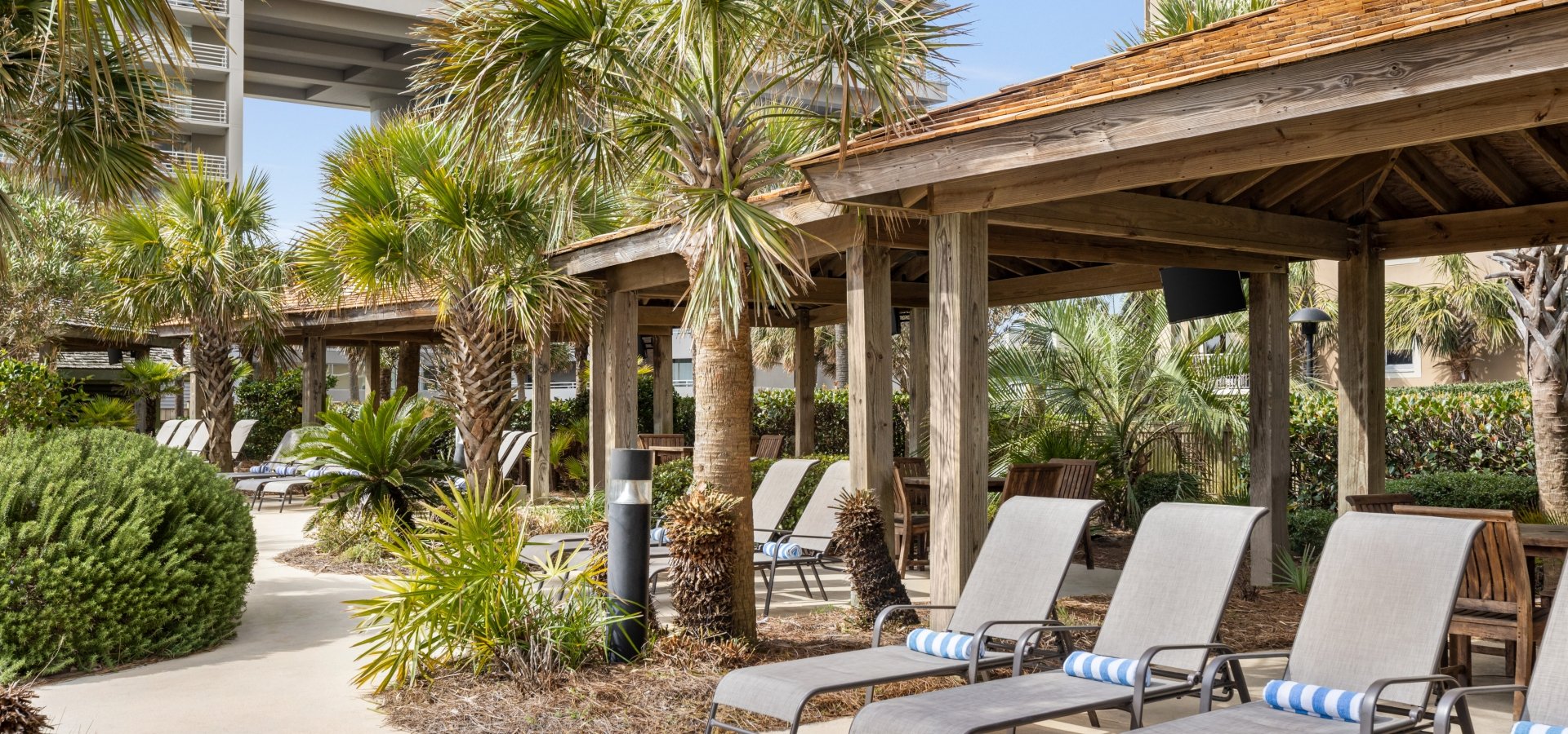 Cabanas and lounge chairs at a rentable Hilton poolside cabana