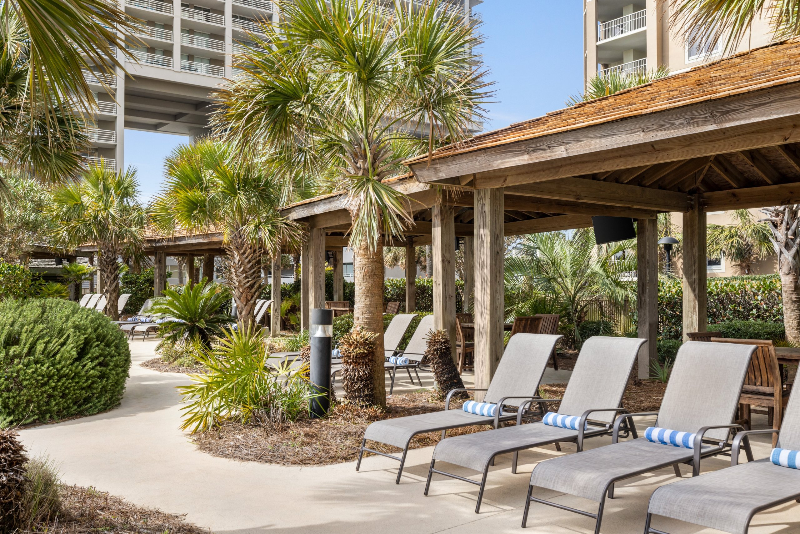 Cabanas and lounge chairs at a rentable Hilton poolside cabana