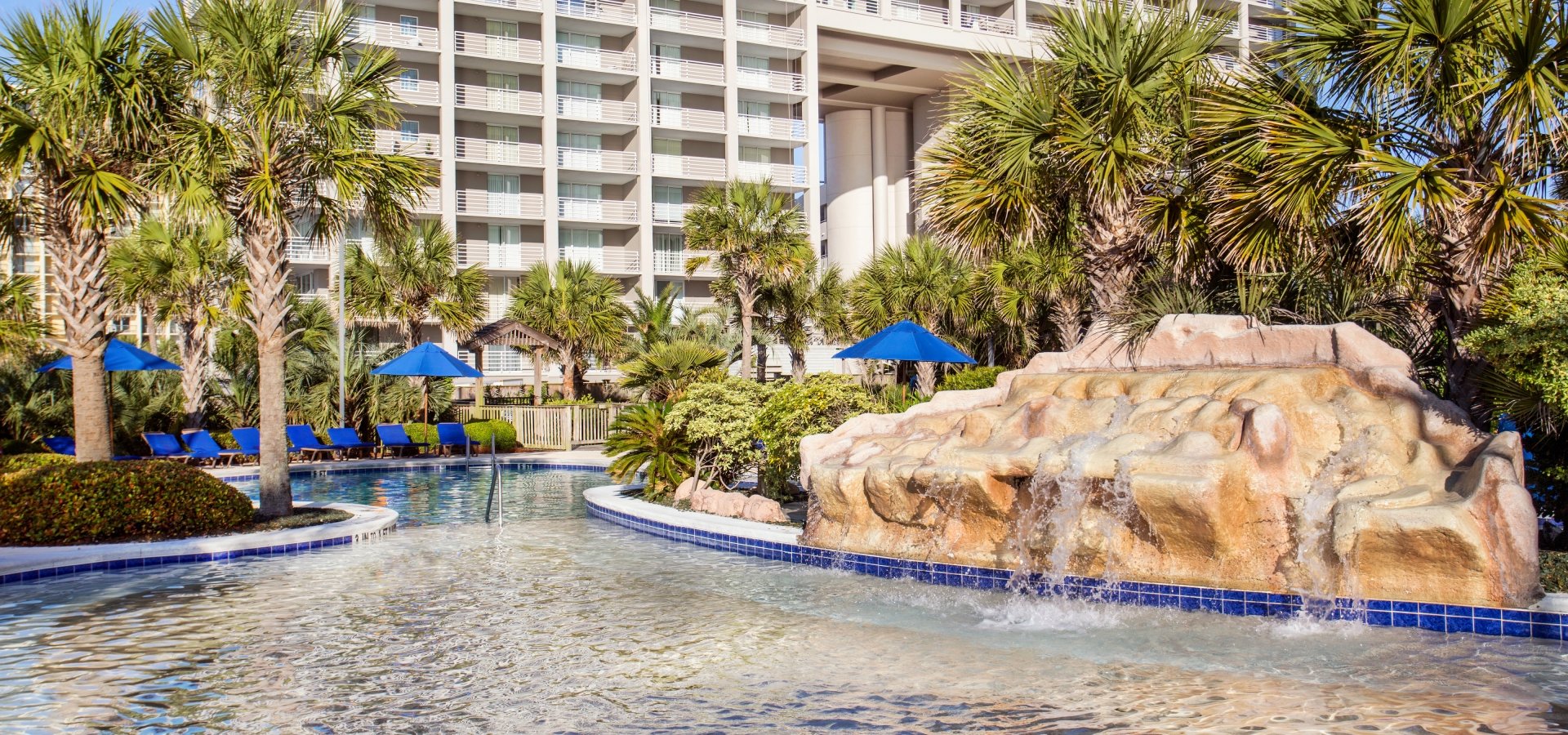 Hilton sand bottom pool and waterfall