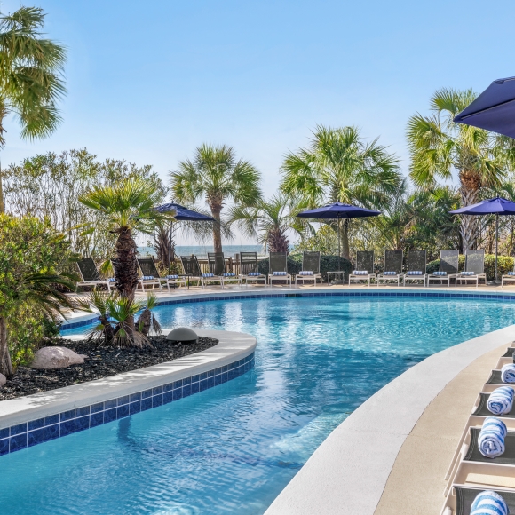 Hilton sand bottom pool and lounge chairs