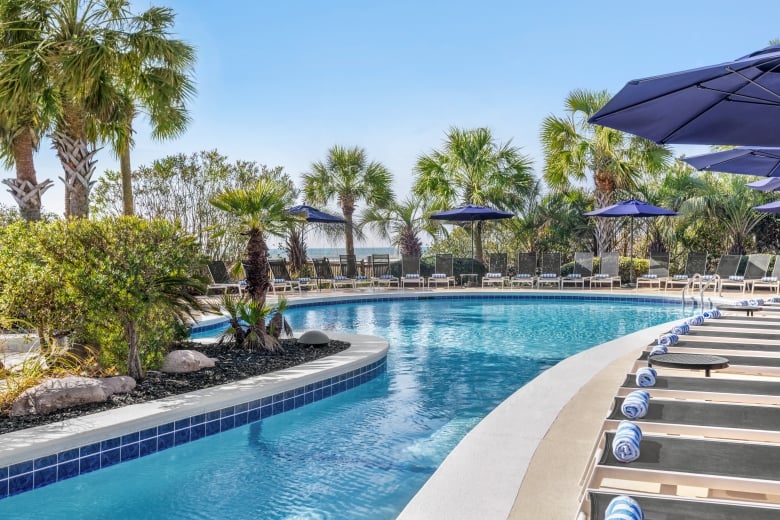 Hilton sand bottom pool and lounge chairs