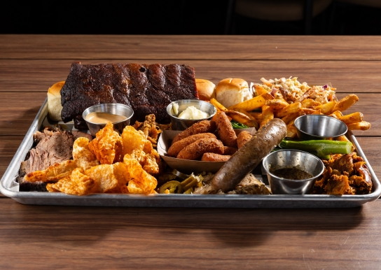 Black Drum Brewing Small BBQ Board consisting of 1/2 rack of ribs, sweet rolls, Cole slaw, French fries, broccolini, pulled chicken, pulled pork, brisket, pork skins, bratwurst, and hush puppies