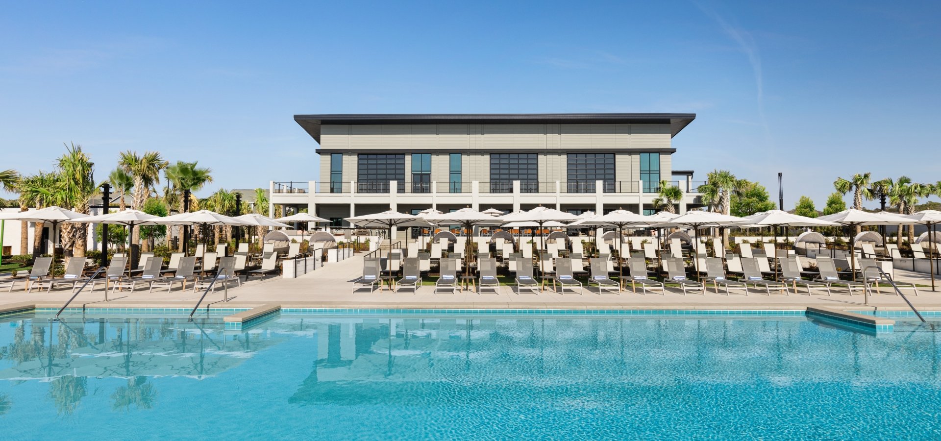 Currents Seaside Entertainment main pool looking at the lounge chairs and Black Drum Brewing