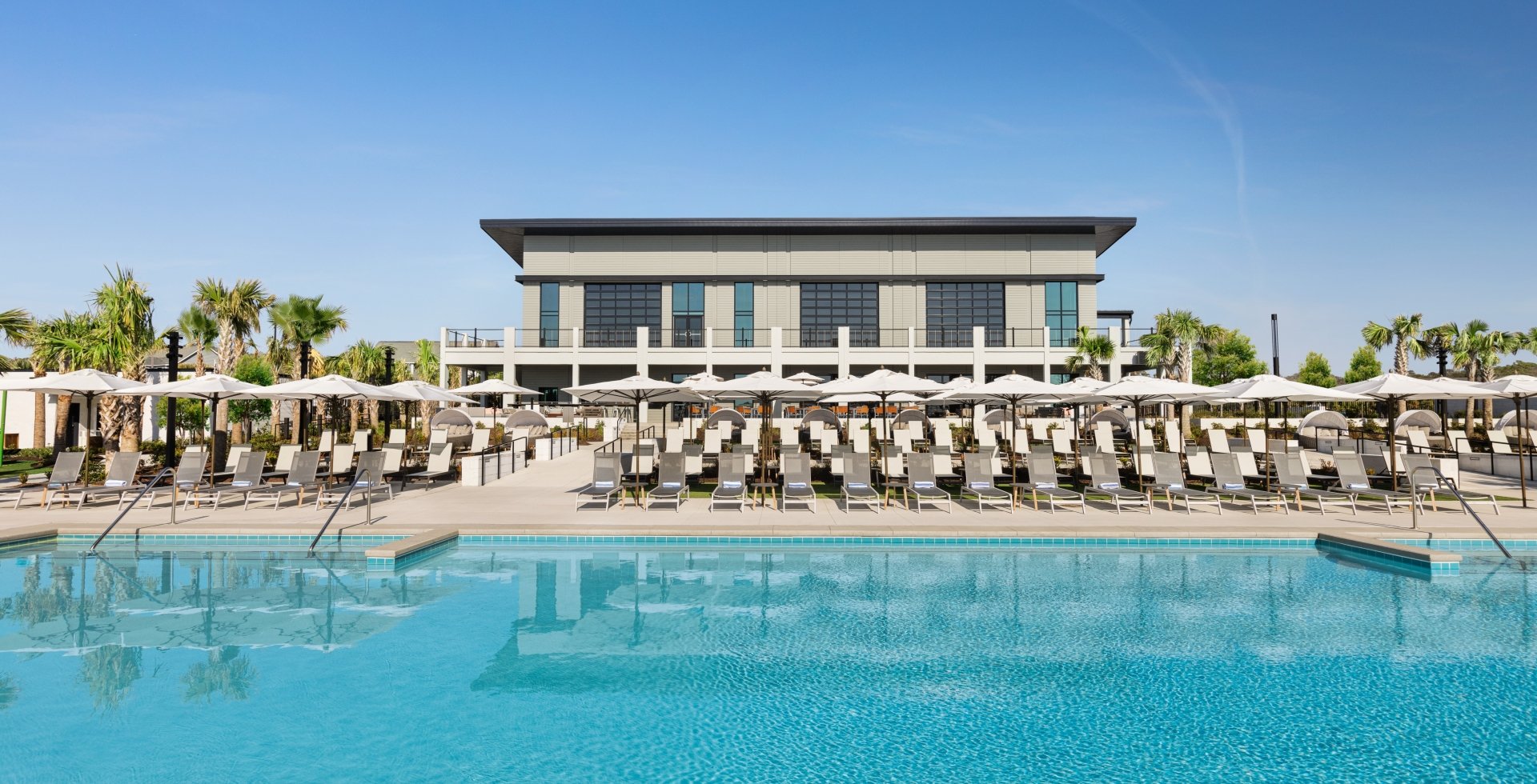 Currents Seaside Entertainment main pool looking at the lounge chairs and Black Drum Brewing