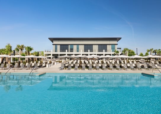 Currents Seaside Entertainment main pool looking at the lounge chairs and Black Drum Brewing