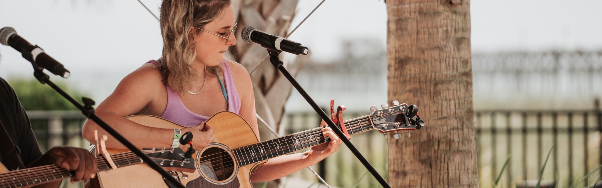 Female live musician on stage with her guitar