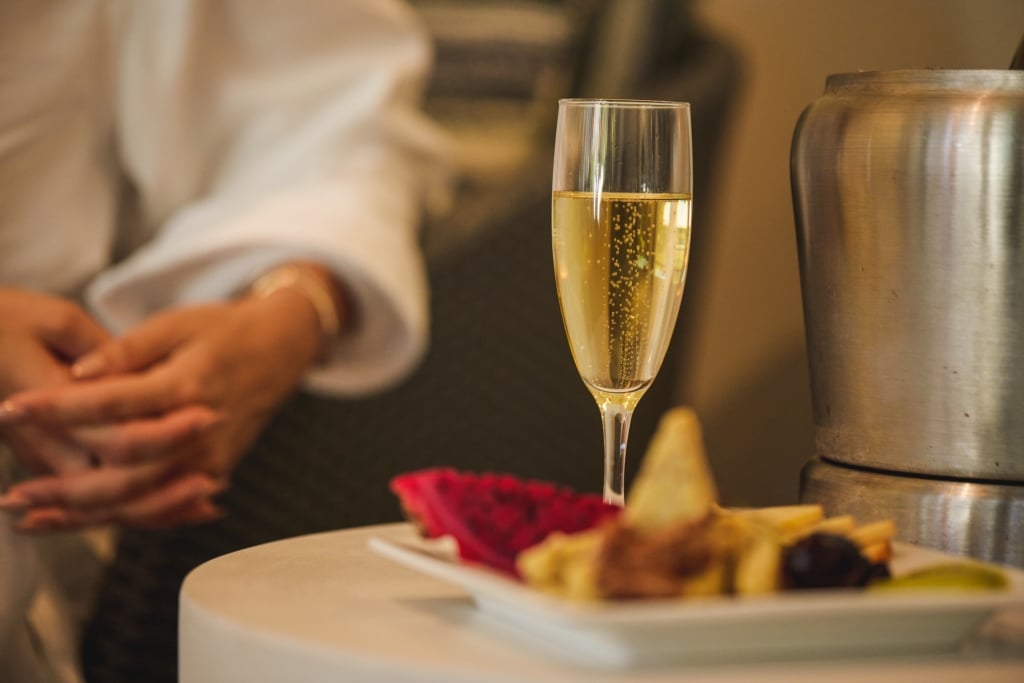 Glass of champagne beside plated food at a Kingston Resorts dinner